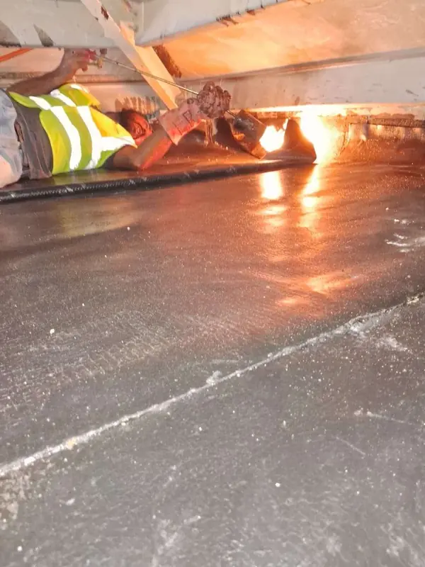 Gas torch heat-welding a bitumen membrane • #1 Waterproofing Company in Dubai & UAE • #1 Waterproofing Company in Dubai & UAE Gas torch heat-welding a bitumen membrane
