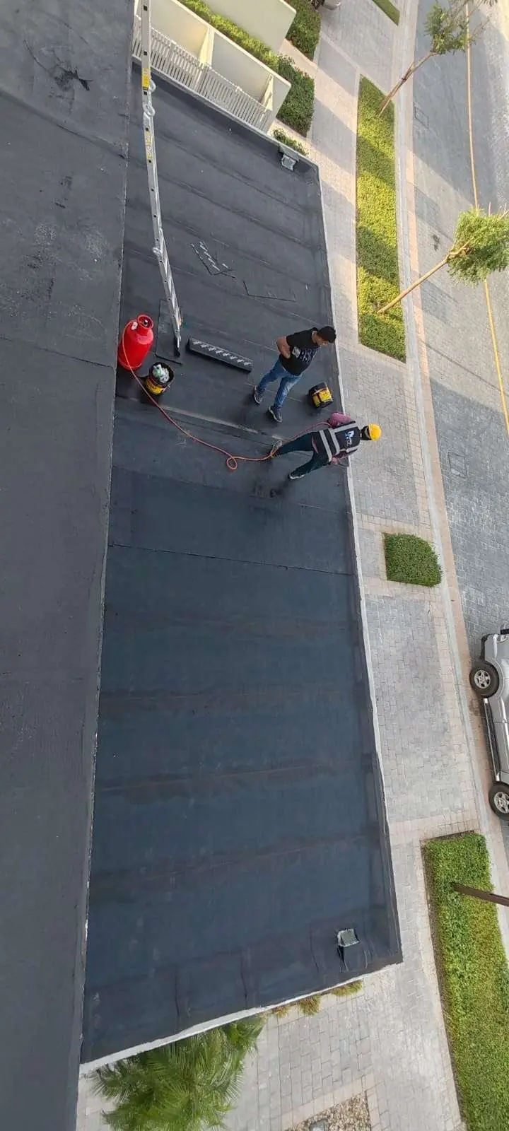 Roof after bitumen membrane installation seen from above • #1 Waterproofing Company in Dubai & UAE • #1 Waterproofing Company in Dubai & UAE Roof after bitumen membrane installation, seen from above